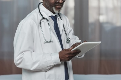 Physician Looking at Tablet